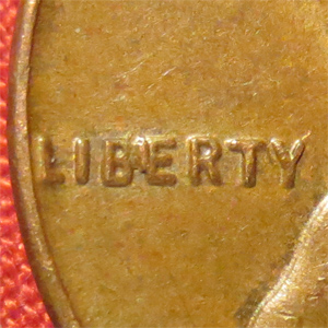 Close-up of 2001 penny BIE error showing raised die crack between B and E in LIBERTY making it appear as LIBIERTY
